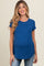 woman wearing a blue short sleeve maternity top with a visible baby bump and smiling