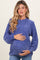 woman wearing a purple maternity sweater with a ribbed neckline and holding her baby bump
