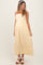 woman wearing a yellow and white striped maternity maxi dress with adjustable straps and a baby bump visible