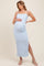 woman wearing a light blue maternity maxi dress with textured stripes and a side slit, showing her baby bump