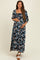 woman wearing a black floral maxi maternity dress with three-quarter sleeves and holding her baby bump