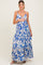 woman wearing a floral blue and white maxi maternity dress with adjustable straps and tiered bottom, showing baby bump