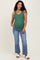 woman wearing a green ribbed maternity tank top and blue flared jeans, showing her baby bump