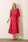 woman wearing a rose pink tiered maxi dress with puff sleeves and a belted waist