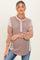 woman wearing a striped maternity top with button details and a relaxed fit, showcasing her baby bump