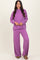 woman wearing a purple ribbed knit long sleeve top and matching wide-leg pants