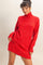 woman wearing a red oversized turtleneck sweater dress with long sleeves and ribbed hem