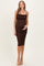 woman wearing a brown sparkly maternity dress with adjustable straps and gathered side details, showcasing her baby bump