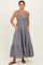 woman wearing a navy and white striped maxi dress with a smocked bodice and pockets