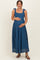 woman wearing a dark blue lace maternity dress with tie straps and holding her baby bump