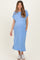 woman wearing a light blue maternity dress with short sleeves and pockets, displaying her baby bump