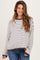 woman wearing a striped maternity sweater in white and brown with a relaxed fit and long sleeves