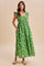 woman wearing a green floral maxi dress with ruffled sleeves and pockets