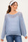 woman wearing a light blue open knit maternity sweater with a relaxed fit and long sleeves, smiling with a headband