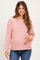 woman wearing a red and white striped long sleeve maternity top and holding her baby bump