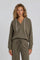 woman wearing an olive green hoodie with a v-neck and drawstring, styled with matching joggers