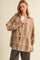 woman wearing a brown plaid oversized button-up shirt with buttons and a relaxed fit