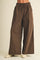 woman wearing brown wide-leg pants with a drawstring waist and side pockets