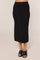 woman wearing a black ribbed midi skirt with a fitted waistband and open-toe black sandals