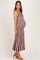 woman wearing a striped maternity maxi dress, showcasing her baby bump, standing sideways with a smile