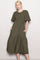 woman wearing an olive green smocked midi dress with short flutter sleeves and pockets
