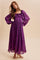 woman wearing a purple floral maxi dress with puff sleeves and a smocked bodice