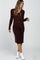 woman wearing a brown ribbed maternity dress with a tie waist detail and long sleeves