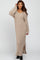 woman wearing a beige ribbed maxi dress with long sleeves and side slits