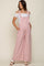 woman wearing a pink maternity jumpsuit with wide legs and side pockets, styled with an off-the-shoulder white top