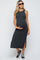 woman wearing a dark gray maternity maxi dress with side slits and holding her baby bump