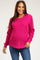 woman wearing a hot pink maternity sweater with a relaxed fit and long sleeves, showing her baby bump