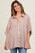 woman wearing a light pink striped maternity top with a button-down front and loose sleeves, smiling at the camera