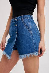 woman wearing a dark blue denim skirt with frayed hem and button details on the front