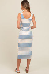 woman wearing a light blue and white striped midi dress with a fitted silhouette and side slit