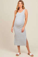 woman wearing a cream and blue striped maternity maxi dress with side slits and a visible baby bump