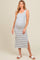 woman wearing a cream and blue striped maternity maxi dress with side slits and a visible baby bump