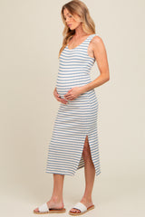 woman wearing a striped maternity midi dress with a side slit, holding her baby bump