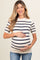 woman wearing a cream and navy striped maternity top and holding her baby bump