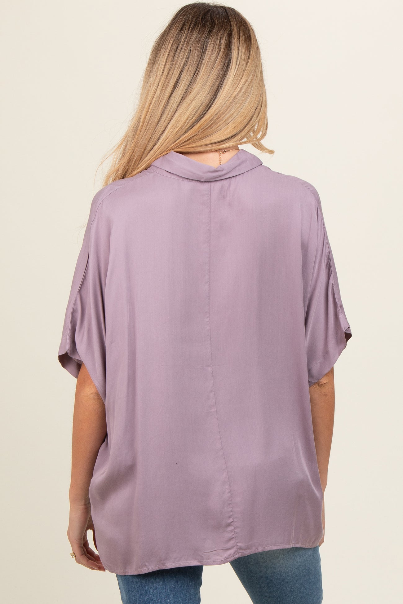 woman wearing a lavender maternity blouse with short sleeves and a loose fit, view from the back