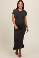 woman wearing a dark gray short sleeve maternity maxi dress and holding her baby bump