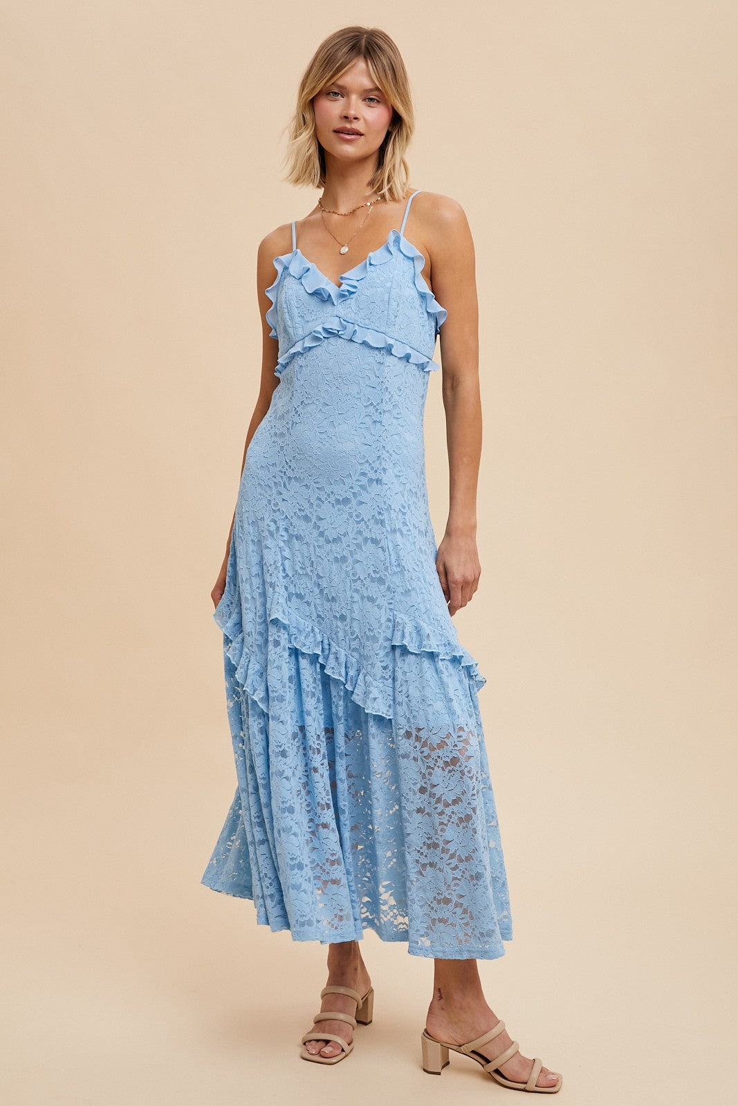 woman wearing a light blue lace maxi dress with ruffled details and spaghetti straps