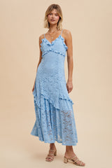 woman wearing a light blue lace maxi dress with ruffled details and spaghetti straps