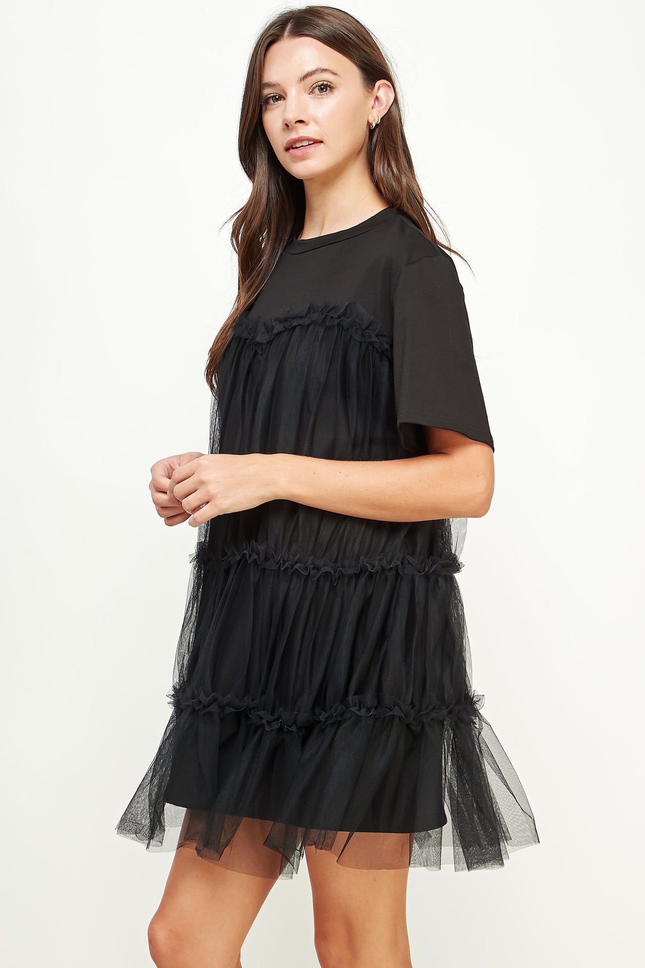 woman wearing a black short sleeve tulle layered dress with a relaxed fit and sheer details