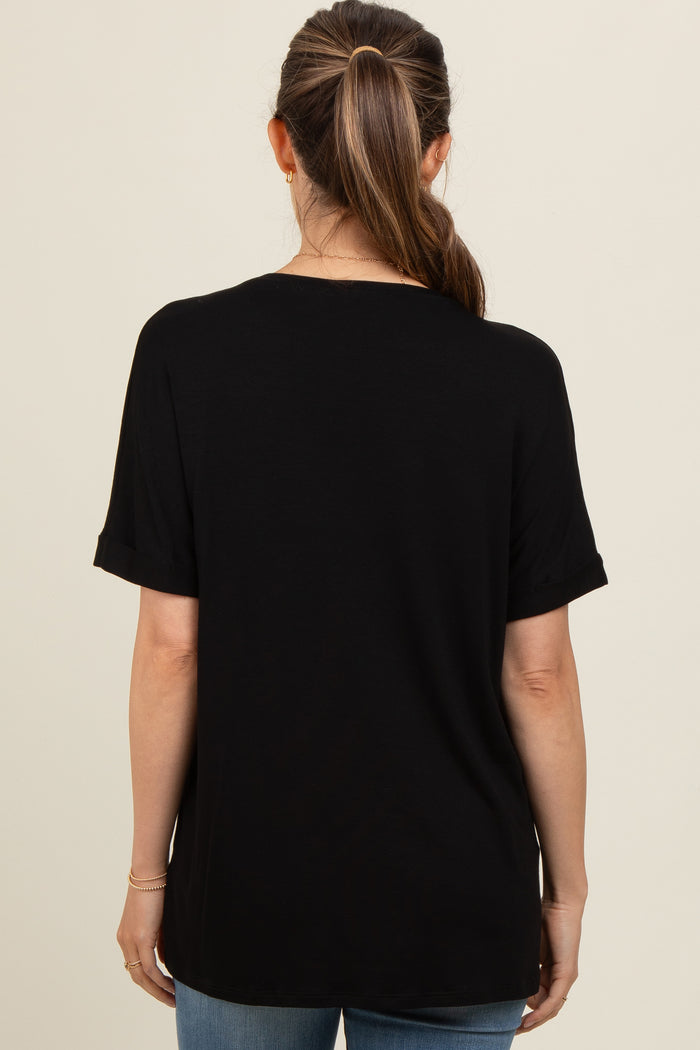 woman wearing a black short sleeve maternity top, shown from the back