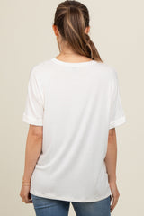 woman wearing a white short sleeve maternity top viewed from the back