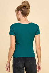 woman wearing a green short sleeve ribbed top with a scalloped hem, shown from the back