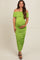 woman wearing a bright green off-the-shoulder maternity dress with ruching and a visible baby bump