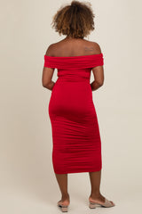 woman wearing a red off-shoulder ruched midi dress, showing a fitted silhouette from the back