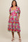 woman wearing a floral maternity dress with puff sleeves, pockets, and a square neckline, showcasing her baby bump