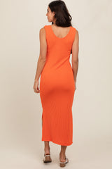woman wearing an orange ribbed midi dress with side slits, viewed from the back